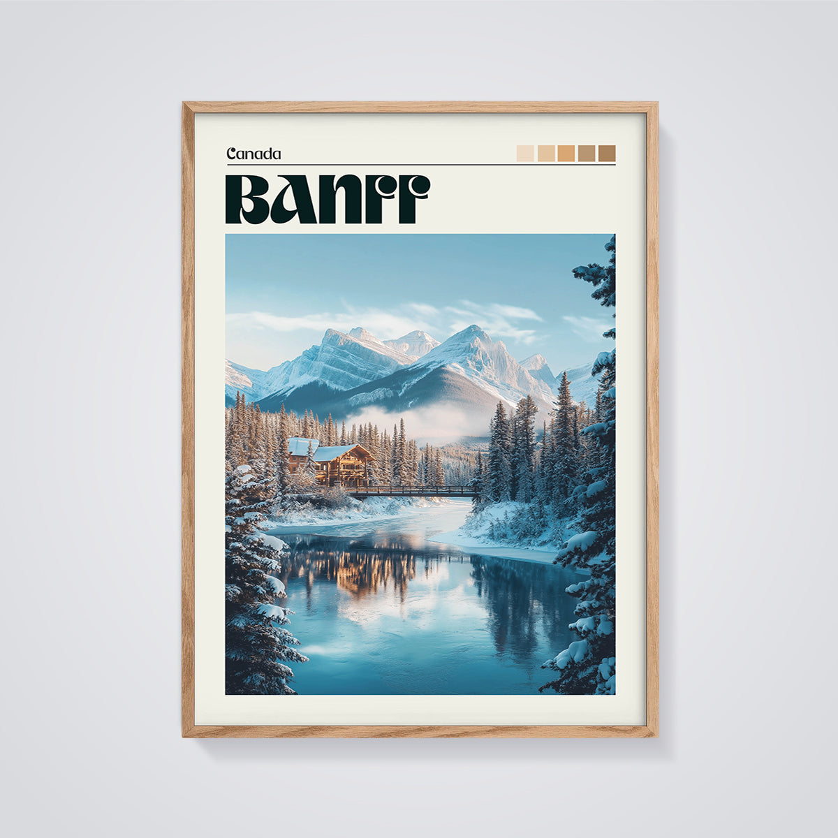 Banff Winter Lodge & Mountains Print framed in oak on a grey background