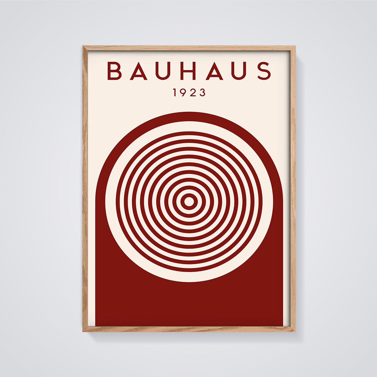 Bauhaus 1923 Concentric Arch Print framed in oak on a grey background