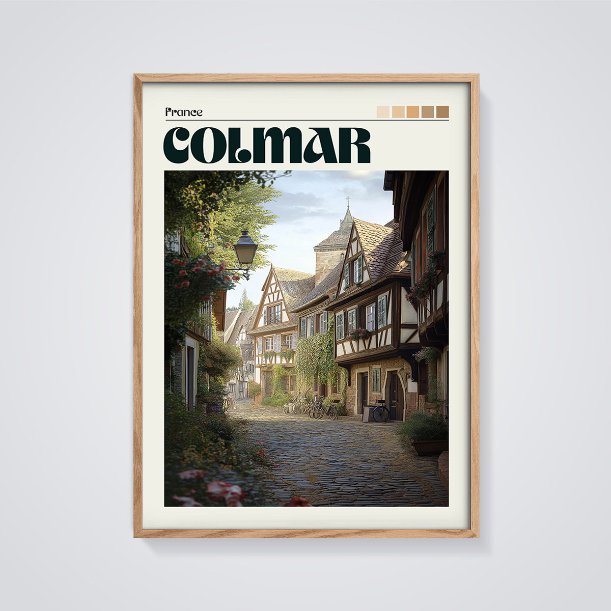 Colmar Cobblestone Street Print framed in oak on a grey background