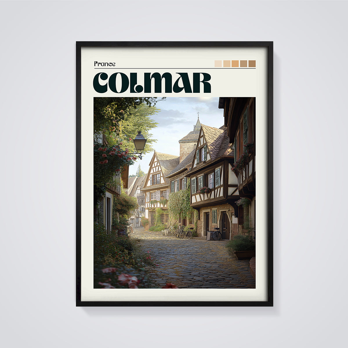 Colmar Cobblestone Street Print framed in black on a grey background