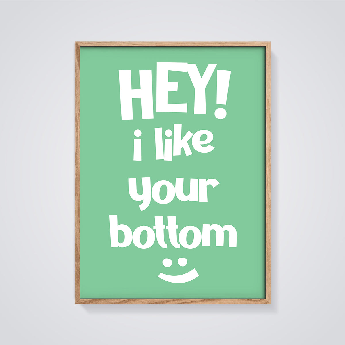 Hey I Like Your Bottom Print framed in oak on a grey background