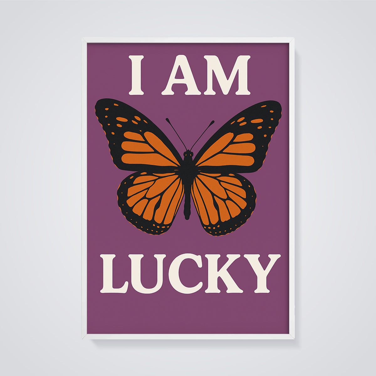 I Am Lucky Monarch Butterfly Print framed in white on a grey background