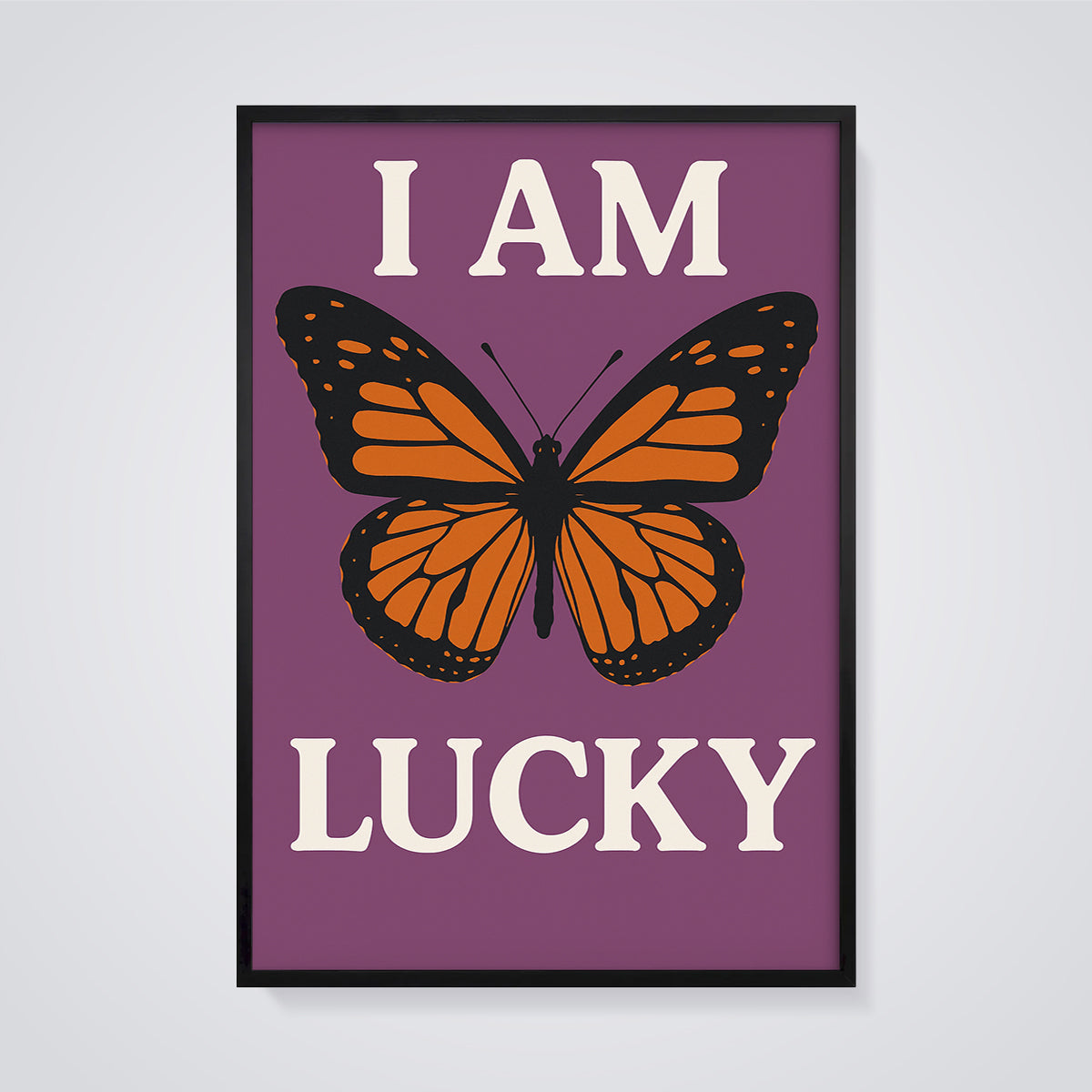 I Am Lucky Monarch Butterfly Print framed in black on a grey background