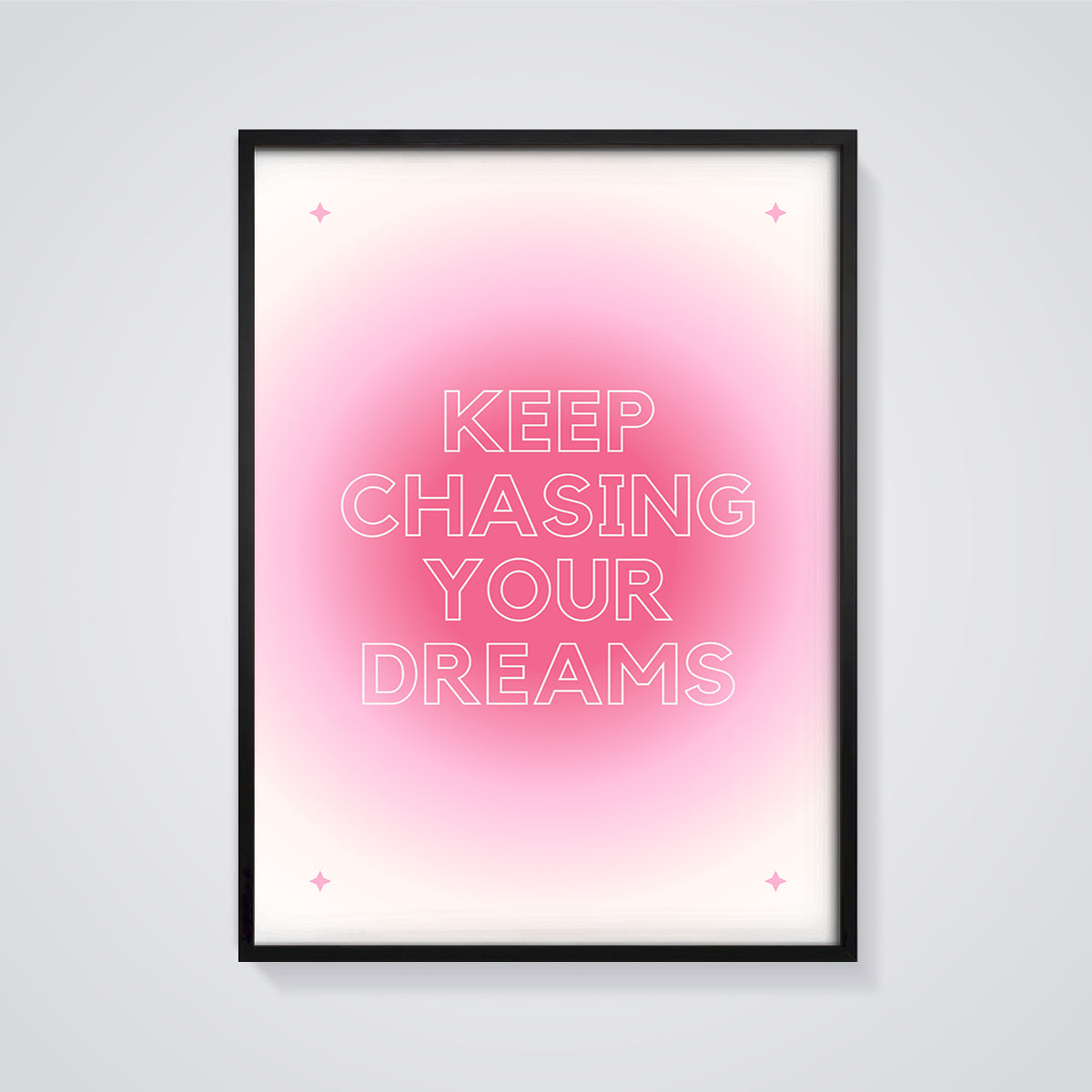 Keep Chasing Your Dreams Quote Print framed in black on a grey background