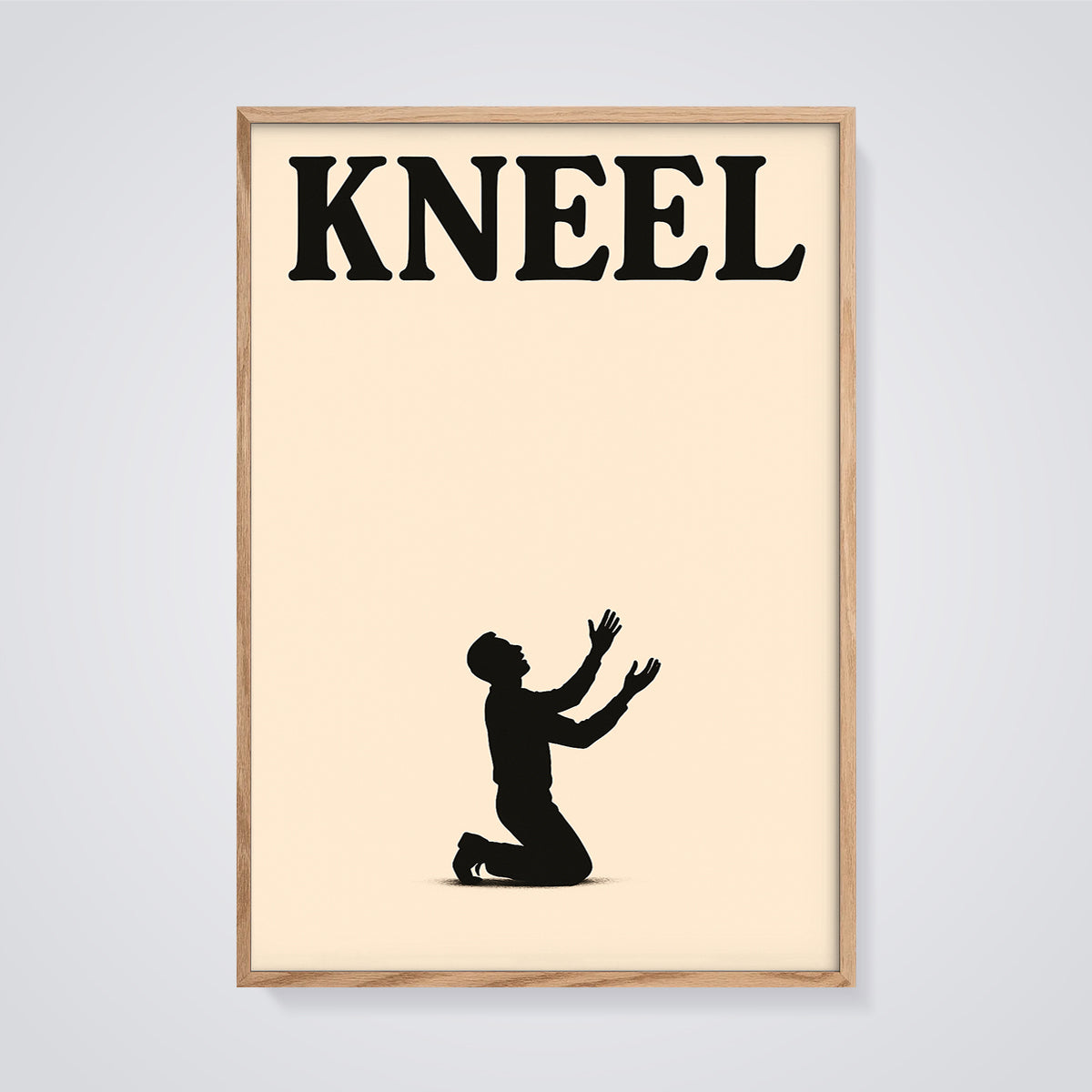 Kneel Silhouette Print framed in oak on a grey background