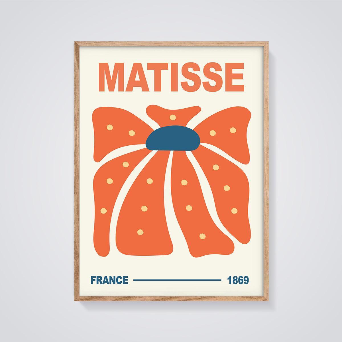 Matisse Orange Bloom Print framed in oak on a grey background