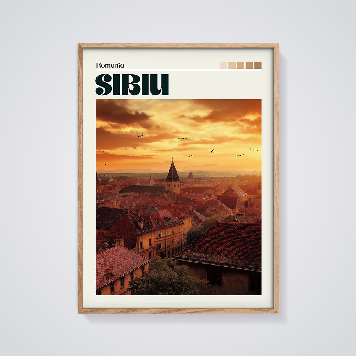 Sibiu Rooftops Sunset Print framed in oak on a grey background