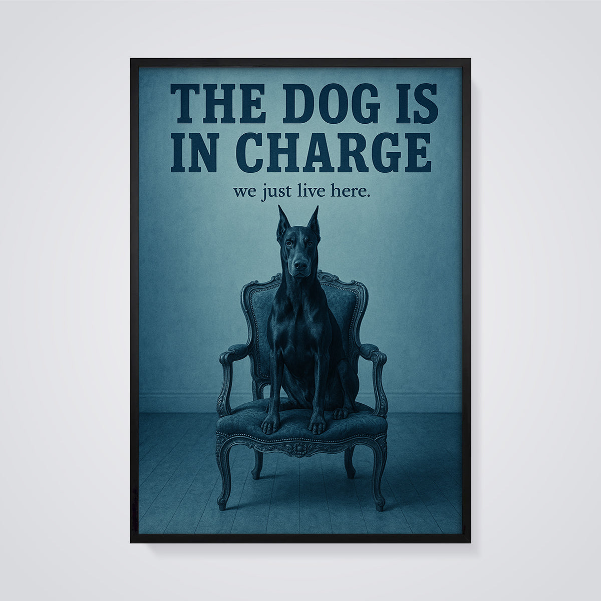 The Dog Is In Charge Doberman Print framed in black on a grey background
