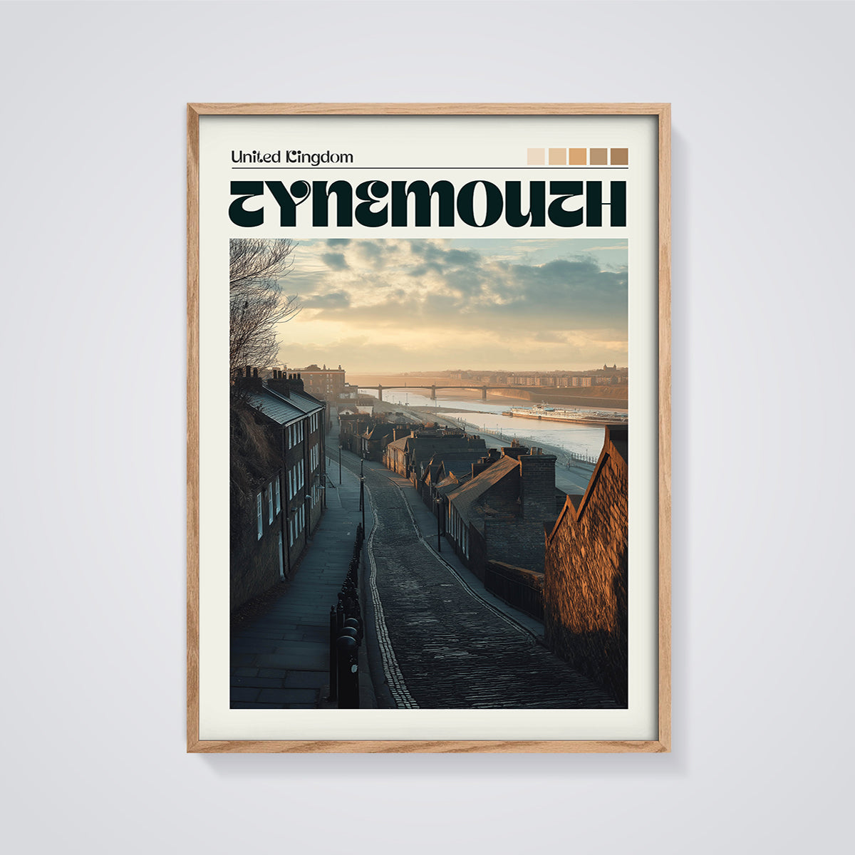 Tynemouth Cobblestone Street Print framed in oak on a grey background
