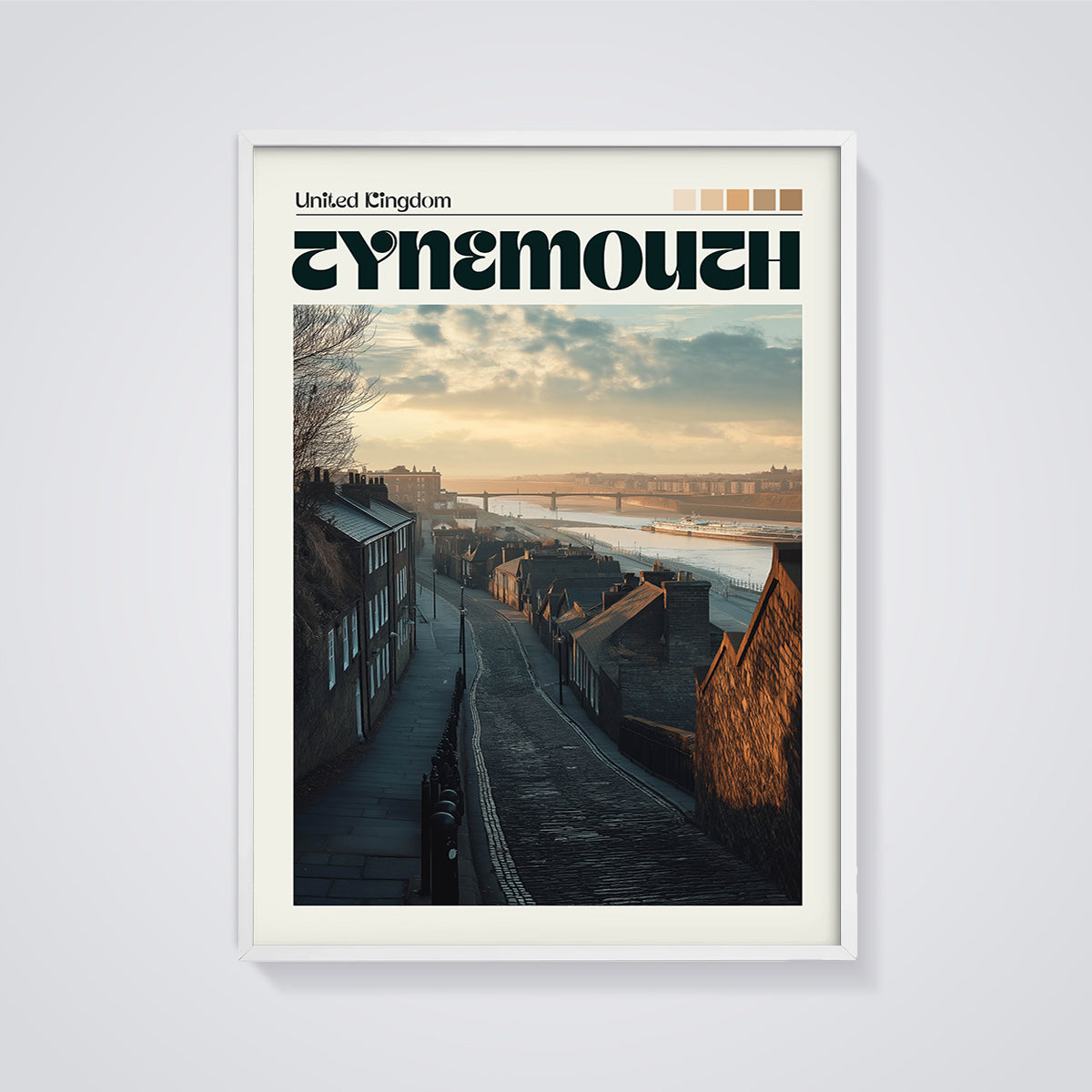 Tynemouth Cobblestone Street Print framed in white on a grey background